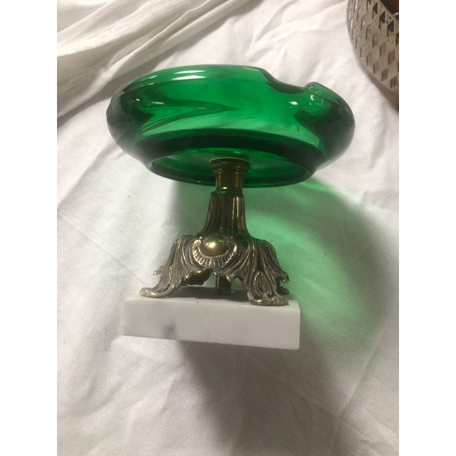 Thank you for checking out our ashtray. A Hollywood Regency green glass ashtray on a marble base is a highly coveted...
