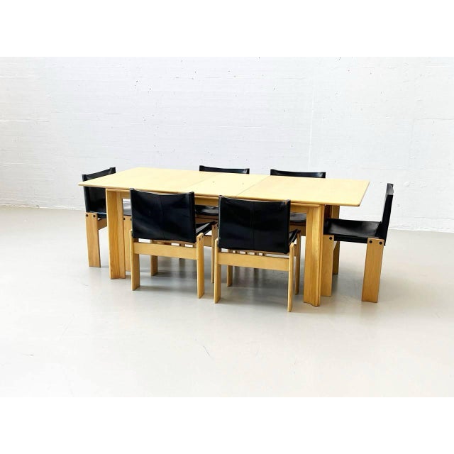 This furniture ensemble is an iconic dining room set designed by italian architects and designers afra and tobia scarpa in...