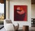 In this minimalist composition with deep shades of red, burgundy, and dusty rose, two figures embrace in a silent,...