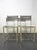 Set of four Spaghetti chairs with gray lacquered steel frames and seats and backs woven with PVC thread. The "Spaghetti"...