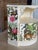 Whimsical vintage demi-lune cabinet featuring a custom hand-painted and decoupaged tropical jungle motif with exotic...