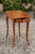 An Italian walnut side table from the early 19th century, with marquetry top, lateral drawer and inlaid legs. Born in...