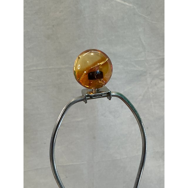 The Arteriors Lucite Bubble Table Lamp is a modern and stylish lighting fixture perfect for a bedroom setting. This lamp...