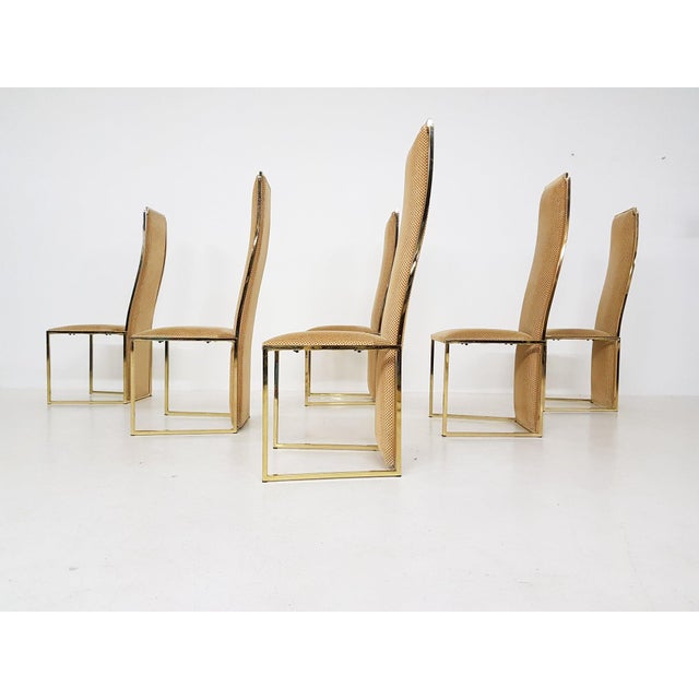 High-end gold plated metal high back dining chairs by Alain Delon. Made and designed in France in the 1980s. A set of six...