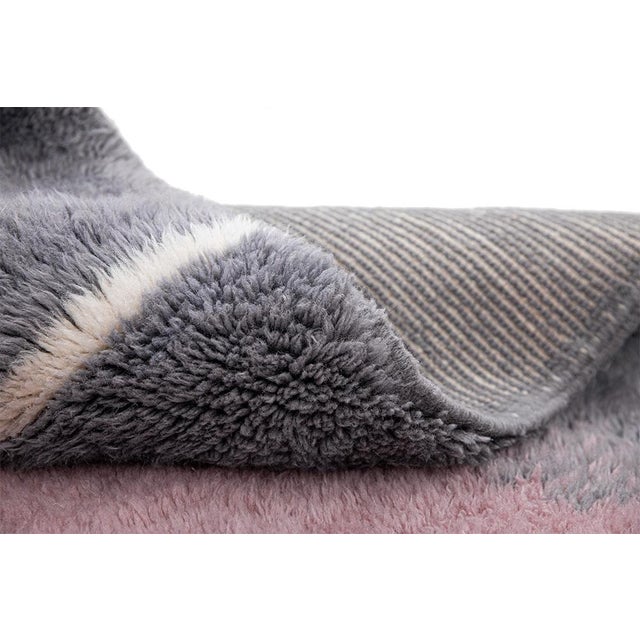 A serene, watercolor-inspired composition — soft rose and lavender-grey tones bloom symmetrically from either edge, fading...