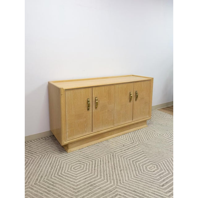 This stunning vintage Hollywood Regency blonde parquetry buffet and credenza is a genuinely beautiful and sophisticated...