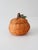 Vintage pumpkin basket in a warm orange finish, with a rounded silhouette, leafy top, and removable lid. A charming accent...