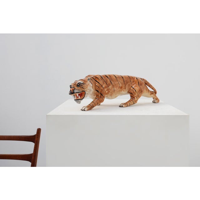 A dramatic mid‑century Italian ceramic sculpture depicting a prowling tiger, hand‑painted in vivid naturalistic tones. The...