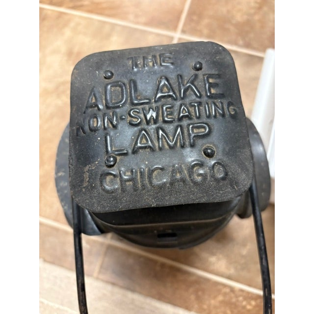 Raised lettering on top say Adlake non-sweating lam Chicago. Two lens. One white. One red. Key locking side complete with...