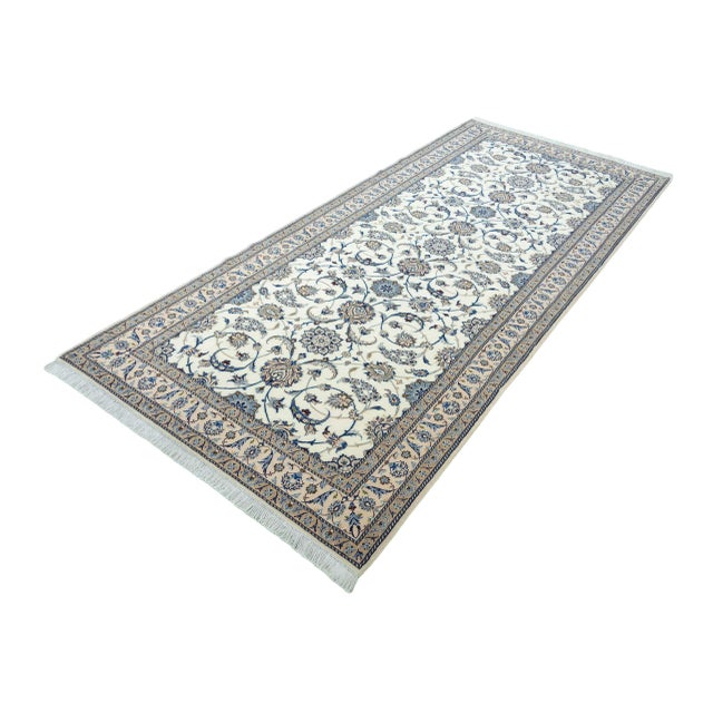 A magnificent, hand-knotted Nain 9La oriental rug with fine weaving and elegant silk details. This elegant piece features...