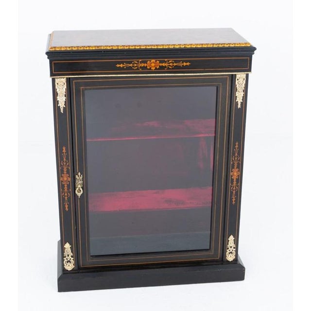 A striking ebonised Victorian pier cabinet of exceptional decorative appeal, raised on a plinth base and finished with...