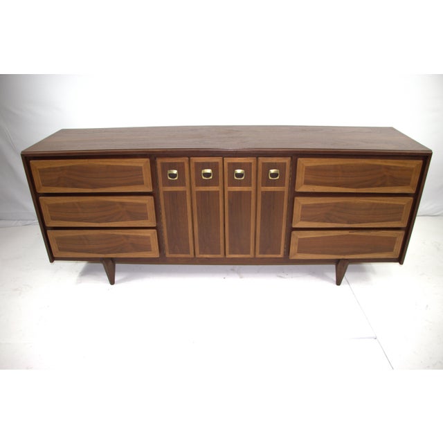 Walnut Mid Century Modern dresser resembles American of Martinsville furniture. Note the elegant two-tone façade of the...