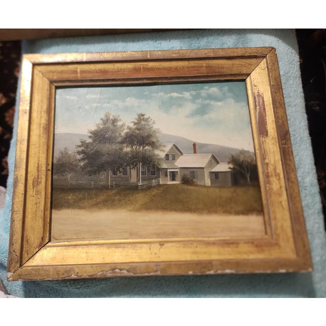 Antique painting of a white house on artist board in a Antique giltwood frame with square nails holding it in. Signed at...