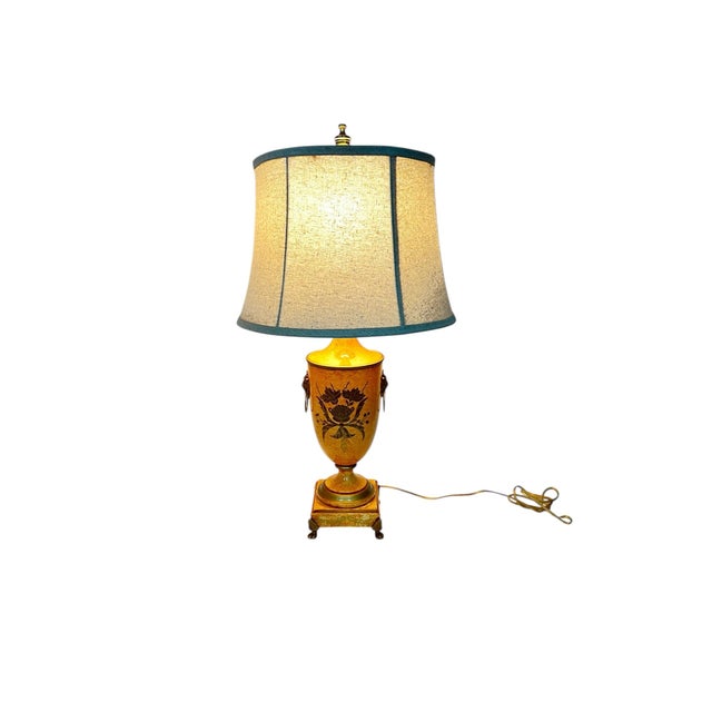 Vintage urn style made in Italy lamp. The metal body is hand painted in modeled pale orange with gold acanthus design....