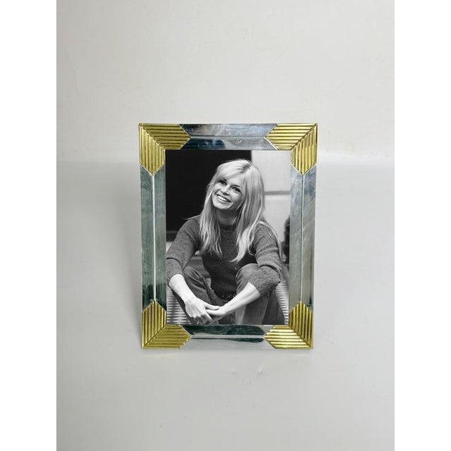 The photo is not provided. Chrome and brass metal photo frame, France, 1970s. An elegant tabletop photo frame combining...