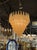 The Murano Gold Granola Glass Tear Drop Chandelier is a stunning and elegant lighting fixture. The chandelier features a...