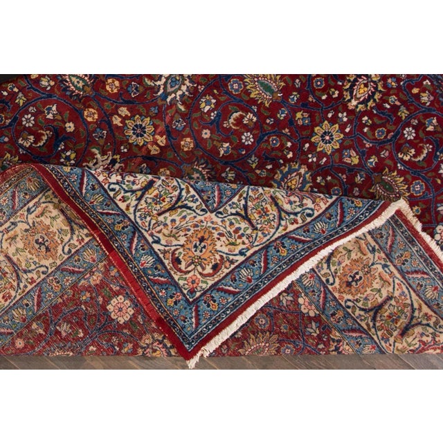 Beautiful vintage Persian Tabriz hand-knotted wool rug with a red field. This piece has a multi-color accent in an all-...