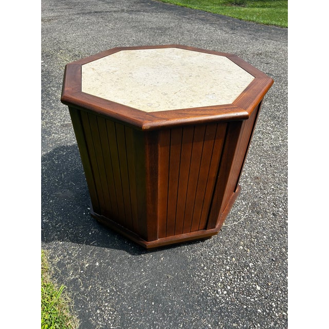 This is a vintage mid-century modern octagonal wooden side table featuring distinctive woven basketweave cabinet doors and...