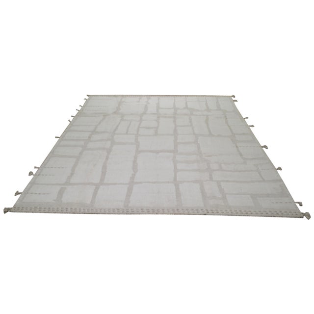 Hand-knotted with care using traditional rug making techniques, this wool rug blends timeless craftsmanship with a modern...