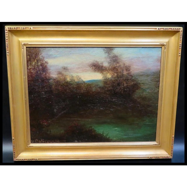 This vintage 20th century oil on canvas displays a picturesque sunset featuring trees & foliage along a brook. The...