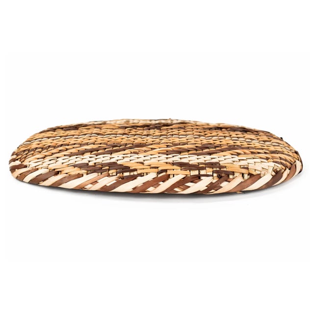A beautiful, handwoven basket from Zimbabwe's Gokwe region with abstract designs in tan and brown.
