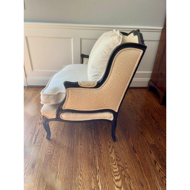 This charming oversized bergère or small settee features black lacquer over mahogany solid wood. The simple carved motifs...
