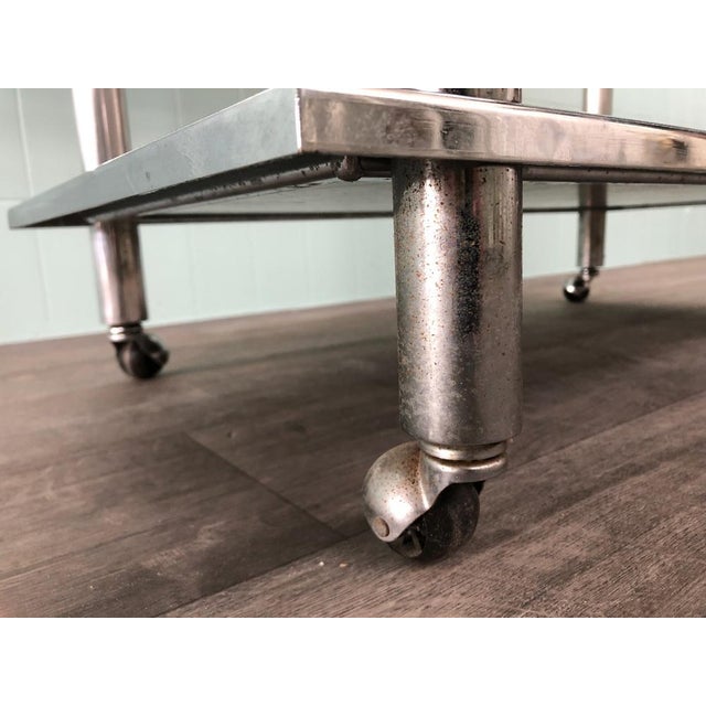 Vintage trolley with 4 wheel Italian manufacture of the 70s Chromed steel structure and shelves in veneered wooden panels.