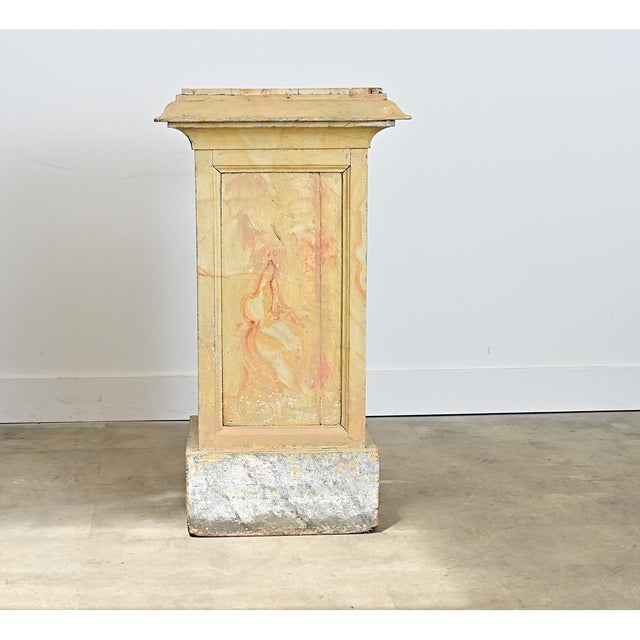 An infinitely useful square display pedestal from France, 19th century, covered in hand-painted faux marble patterns on...