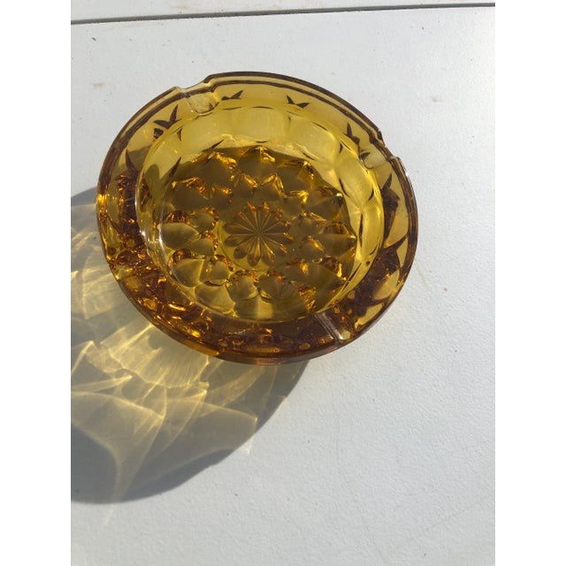 Unique Vintage Mid-century modern era amber ashtray. Graduating 12 point flower or star pattern on raised bottom side....