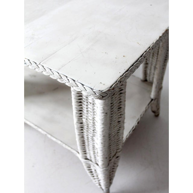 This antique wicker library table offers timeless appeal. Its intricate woven design and white finish create a...