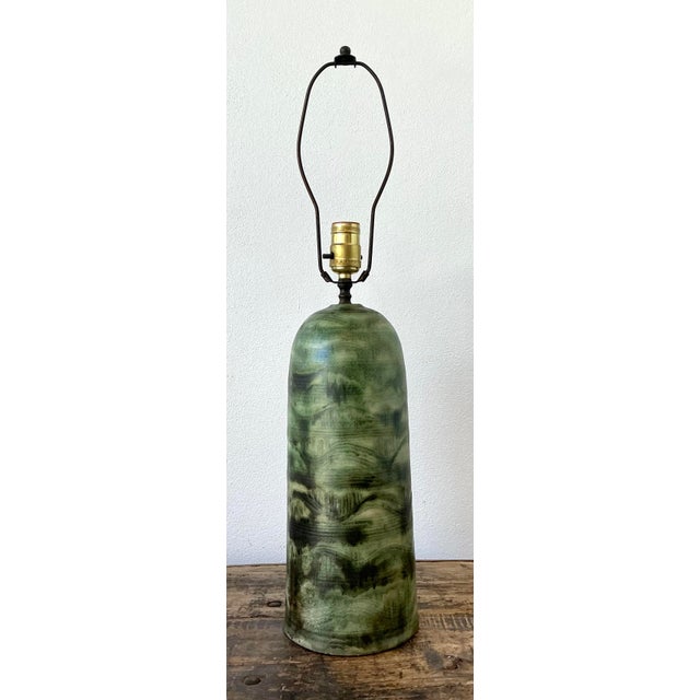 This sculptural table lamp is a striking example of Mid-Century Modern studio pottery, blending organic form with an...