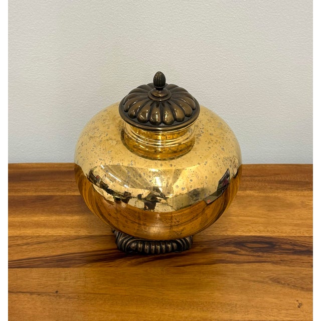 Handcrafted Maitland-Smith lidded decorative jar featuring a bulbous polished brass body with a warm, lightly mottled...