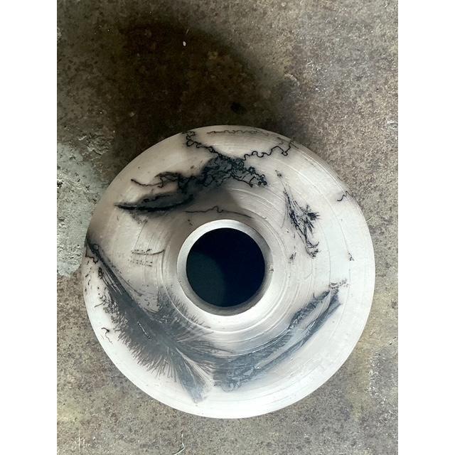 This exquisite ceramic piece is a testament to sophisticated modern craftsmanship, utilizing the specialized Raku firing...