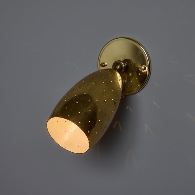Pair of 1950s Mauri Almari Perforated Brass Sconces for Itsu. A contemporary of Paavo Tynell, the refined work of Mauri...