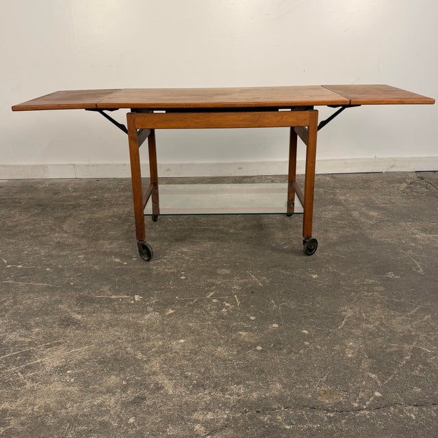 This Jens Risom bar cart is in structurally sound vintage condition. The cart is solid, stable, and fully functional, with...