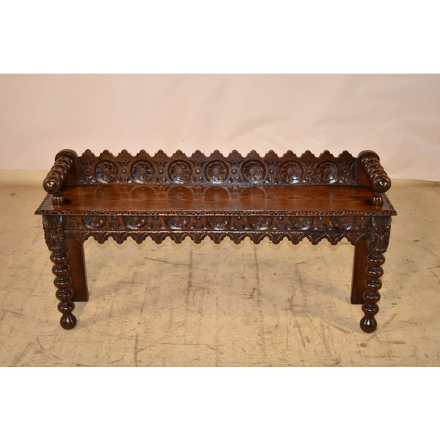 19th century English oak hand carved window seat. This window seat has a lovely hand-carved and scalloped back, following...