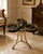 A distinctive vintage Maitland-Smith trefold side table featuring three circular black tooled-leather surfaces arranged in...