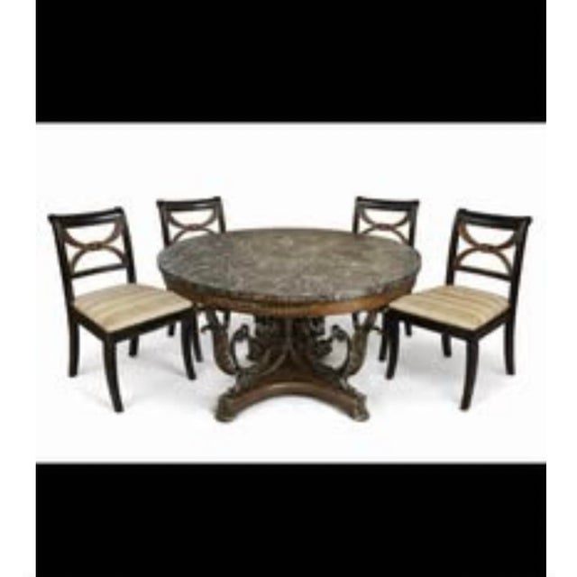 Elevate your space with this exquisite Empire Revival center table, masterfully crafted with a richly veined dark marble...