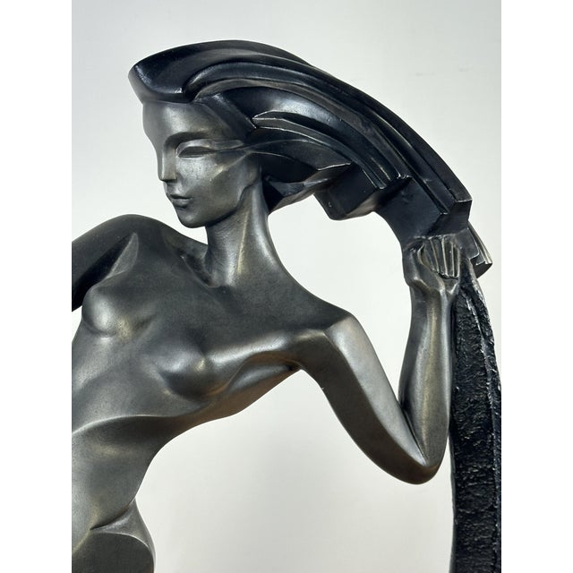 Large Art Deco style spelter statue "The Draped Dancer" with a metallic black patina on a black plaster base by Alexsander...