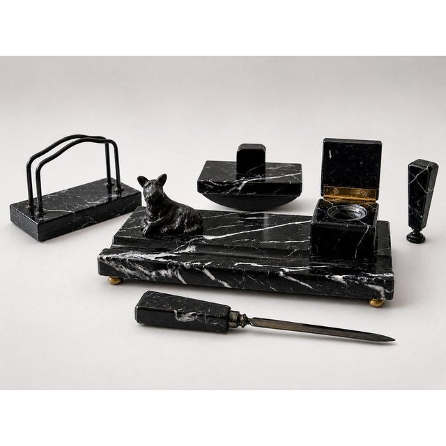 A striking and complete Swedish Art Deco desk set in richly veined black marble, dating from the 1930s. This refined...