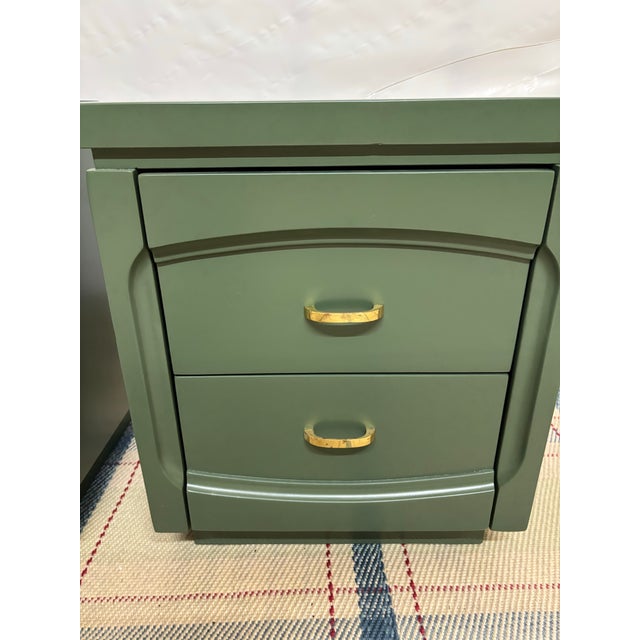 Pair of vintage nightstands painted professionally in a smooth, matte olive green finish.Each unit features a blocky, mid-...