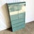This striking postmodern armoire showcases a bold faux–teal granite laminate wrapped in dramatic waterfall curves,...