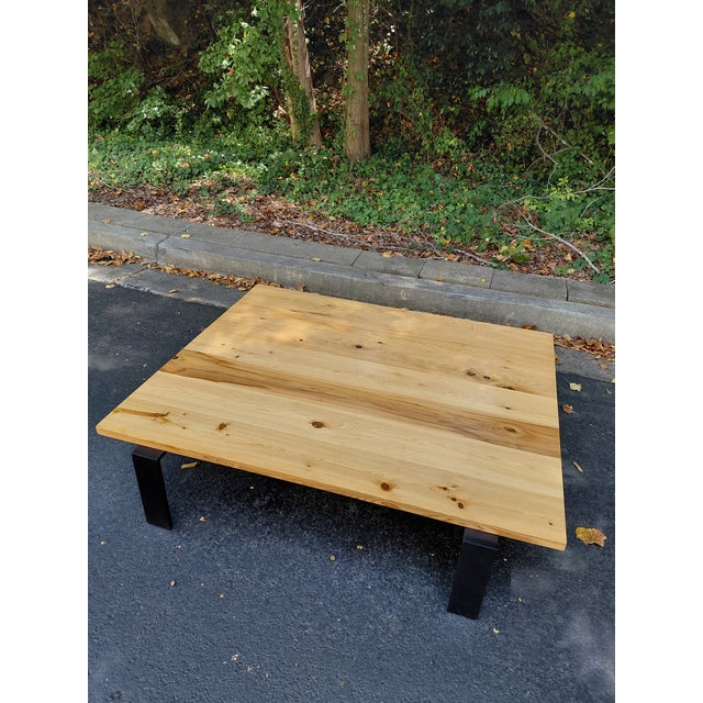 A substantial cocktail table by Ralph Lauren Home, combining relaxed rustic character with clean architectural lines. The...