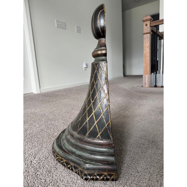 A dramatic pair of large decorative wall sconces featuring hand-carved wood construction with individually applied brass...