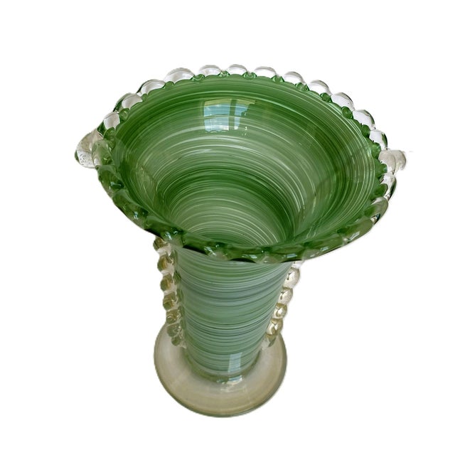 A stunning vintage Murano art glass vase in a flared trumpet form, featuring a luminous mint-green spiral design and...