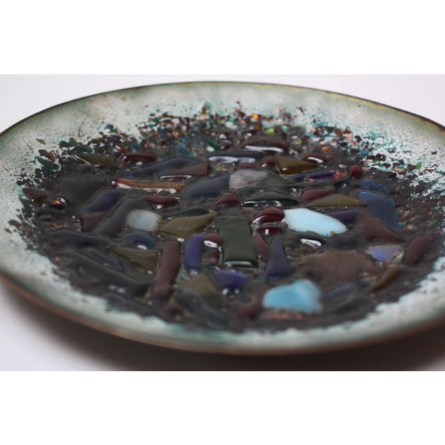 Exceptional 1960s enamel on copper dish measuring 7.75" in diameter. This work incorporates fusing powdered glass to...
