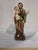 This religious figurine represents Saint Joseph holding the Child Jesus, sculpted with traditional devotional proportions...