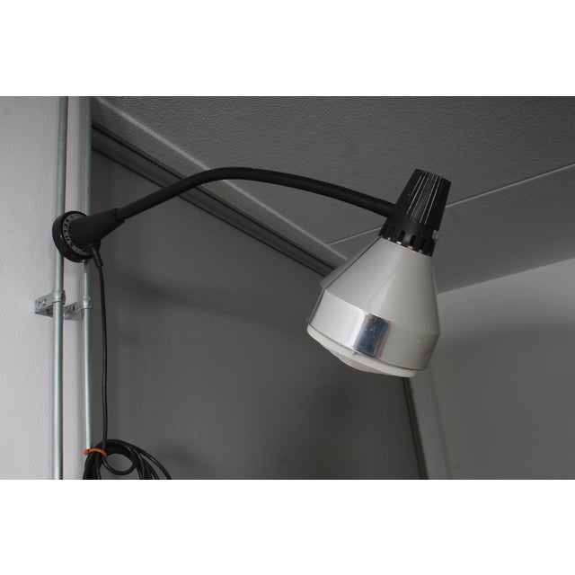 This lamp can be hung on metal surfaces using its magnet. This piece has an attribution mark, I am sure that it is...