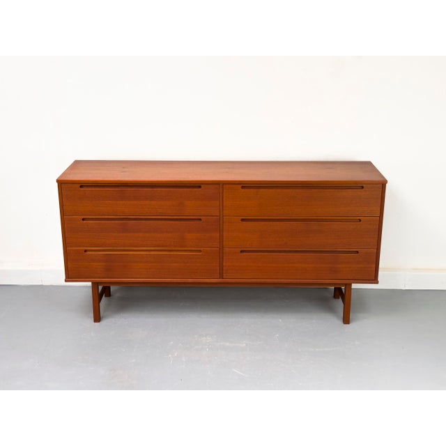 Elegant Danish mid-century teak sideboard, crafted by Tørring Møbelfabrik. The sideboard features six spacious drawers,...