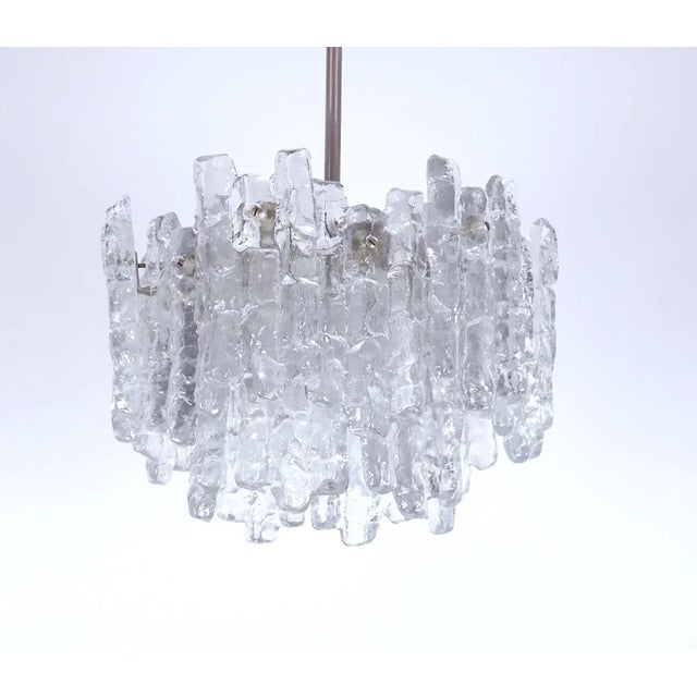 Beautiful heavy chandelier by jt kalmar austria with murano ice glass designed in the 1960s. the lamp has a metal frame...